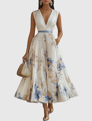 White pleated maxi dress with V-neck, floral print and gathered waist, sleeveless.