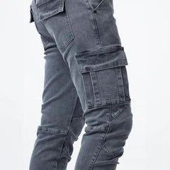 Grey utility jeans detail view with stacked cargo pockets and stitched panels