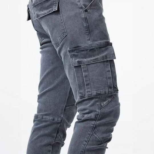 Grey utility jeans detail view with stacked cargo pockets and stitched panels