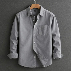 Grey long-sleeve button-up shirt with chest pocket and diagonal front panel.