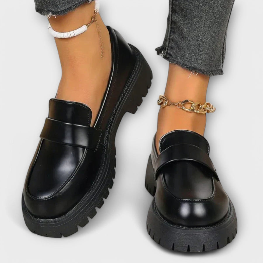 Zelvana black moccasin platform loafers with chain ankle strap, rounded toe