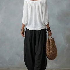 White off-shoulder top and black lantern trousers set, back view