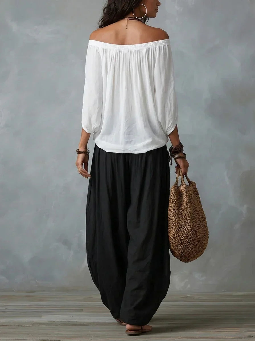 White off-shoulder top and black lantern trousers set, back view