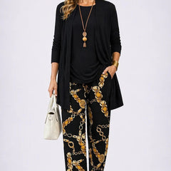 Black 3-piece set with open-front jacket, black top, and gold chain print pants