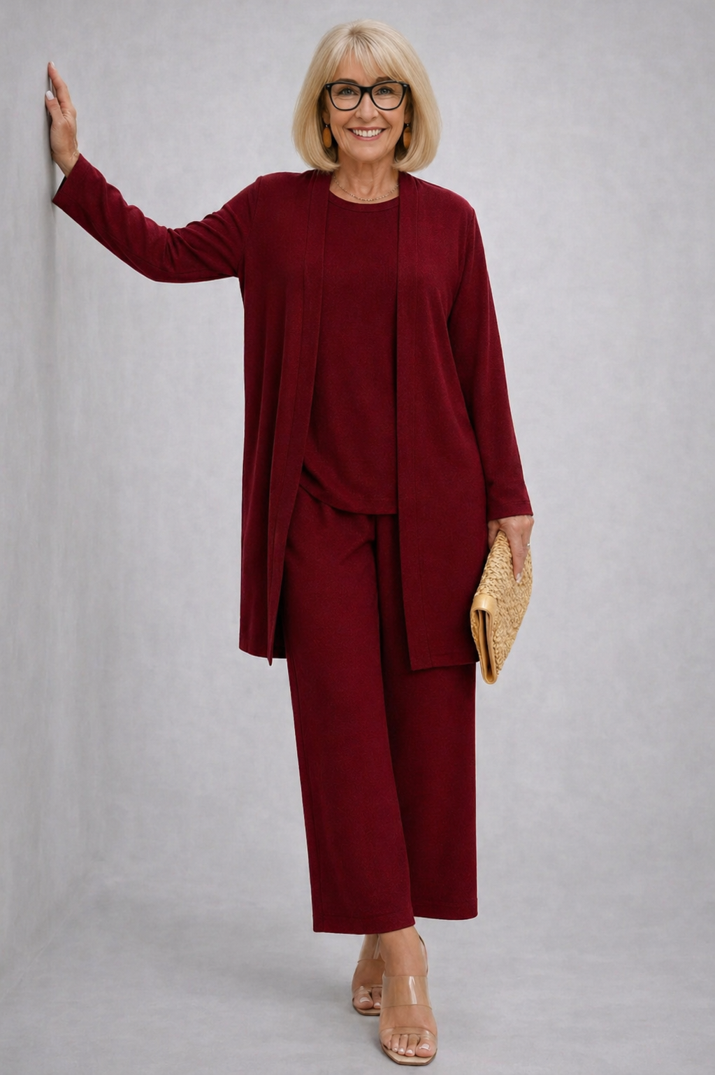 Burgundy elegant 3-piece set with long cardigan, layered top, and wide-leg pants.