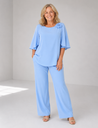 Light blue two-piece top and wide-leg pants set with ruffle shoulder detail