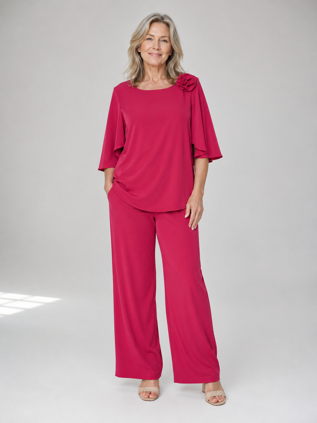 Red two-piece top and wide-leg pants set with ruffle shoulder detail