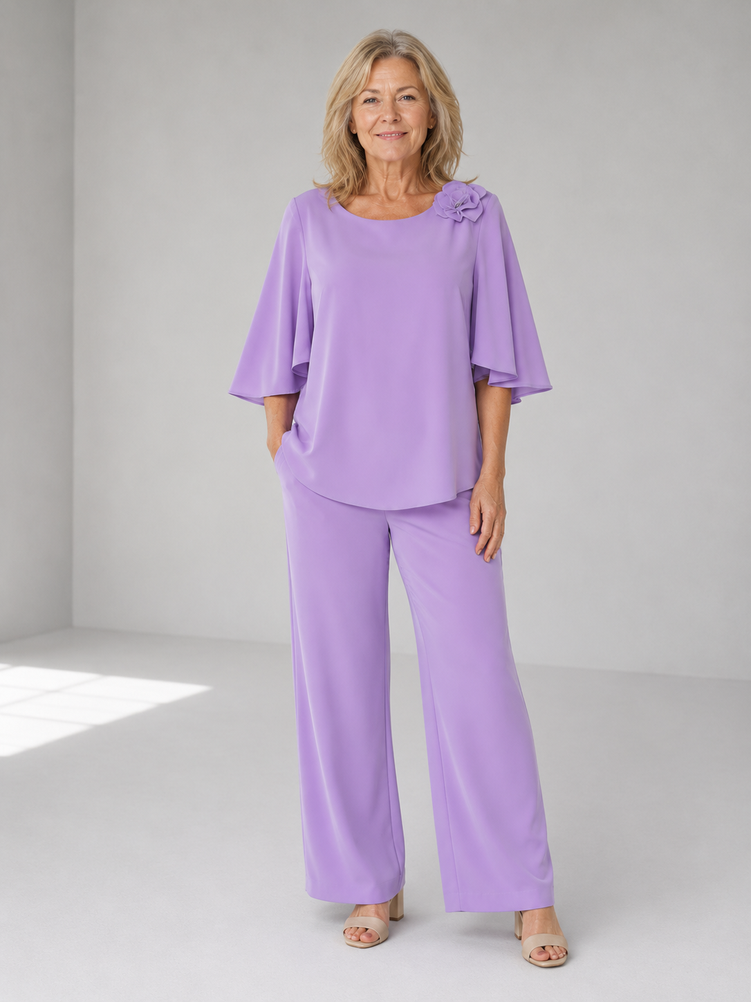 Lavender two-piece top and wide-leg pants set with ruffle shoulder detail