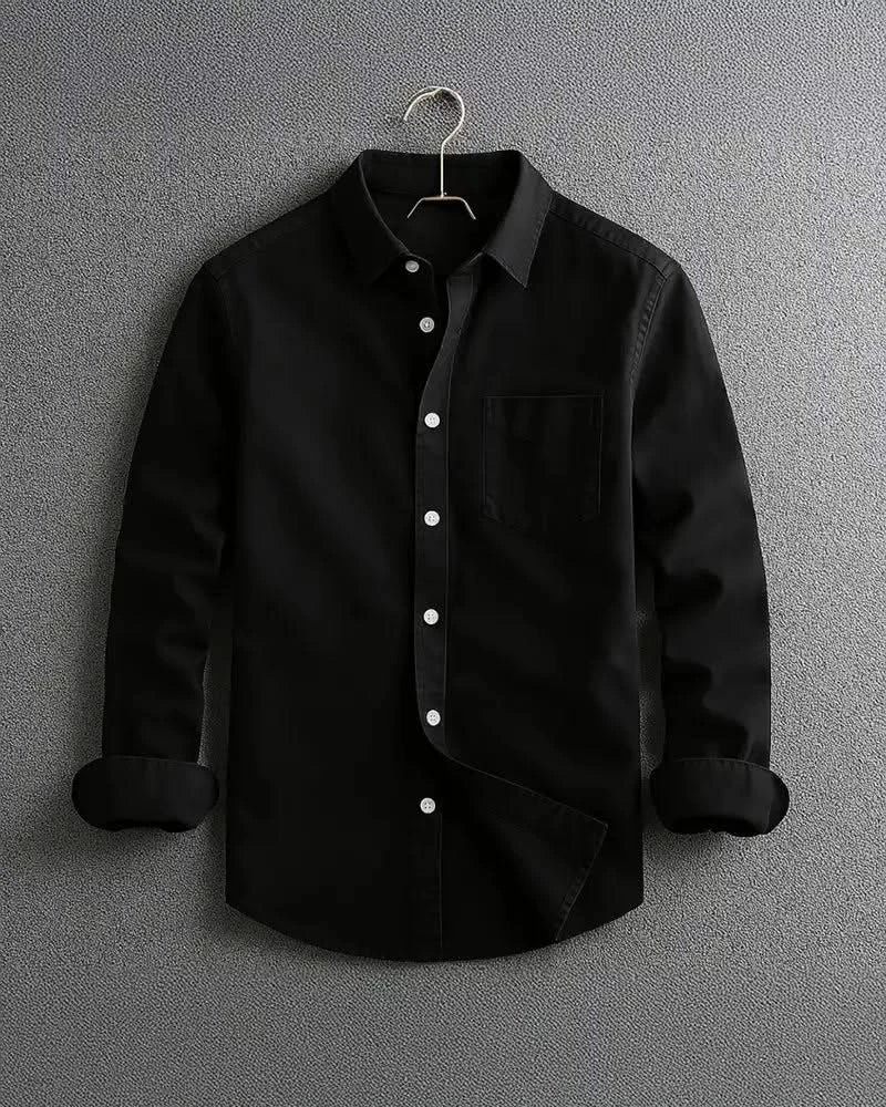 Black long-sleeve button-up shirt with chest pocket and diagonal front panel.
