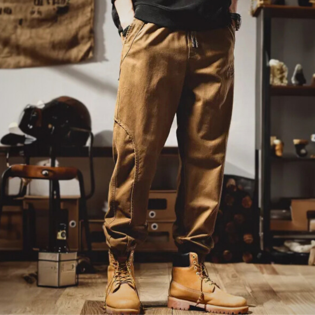 Brown cargo pants with cargo pockets and lace-up boot cuffs, side view