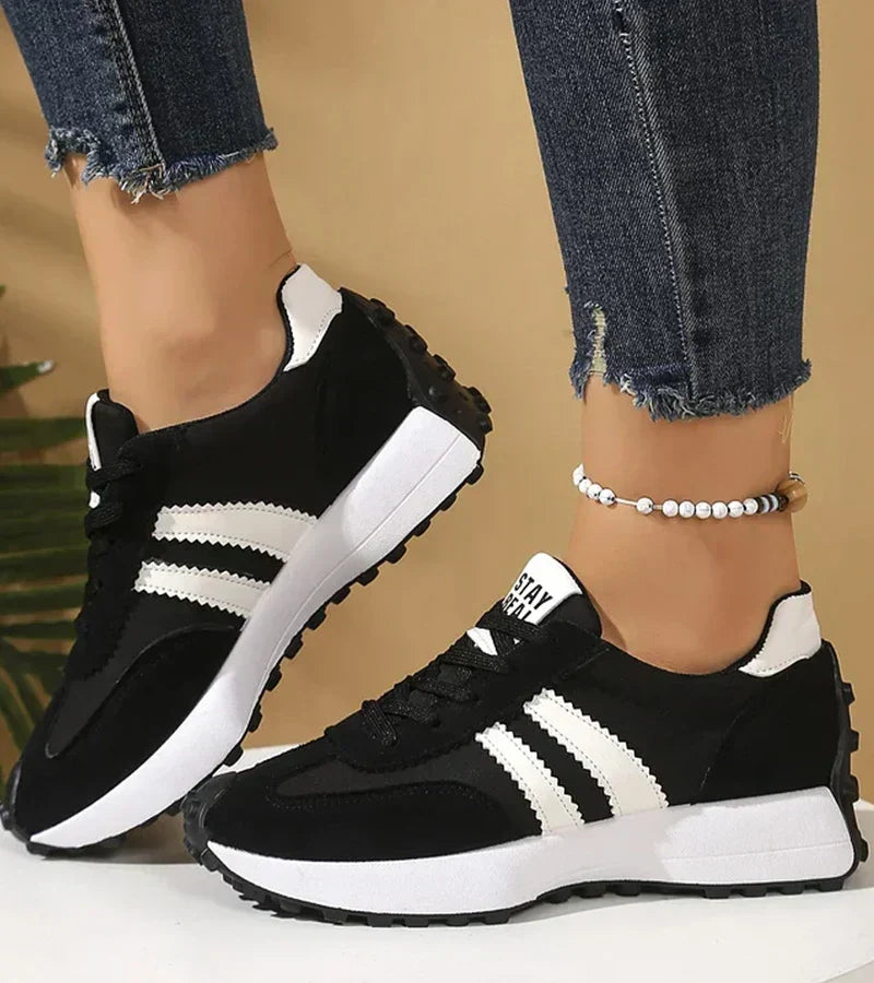 Everyday comfort sneakers, black with white stripes and lace-up low-top design