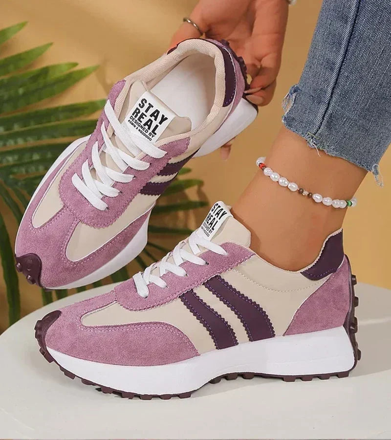 Purple and white everyday comfort trainers with white laces and dark stripe accents.