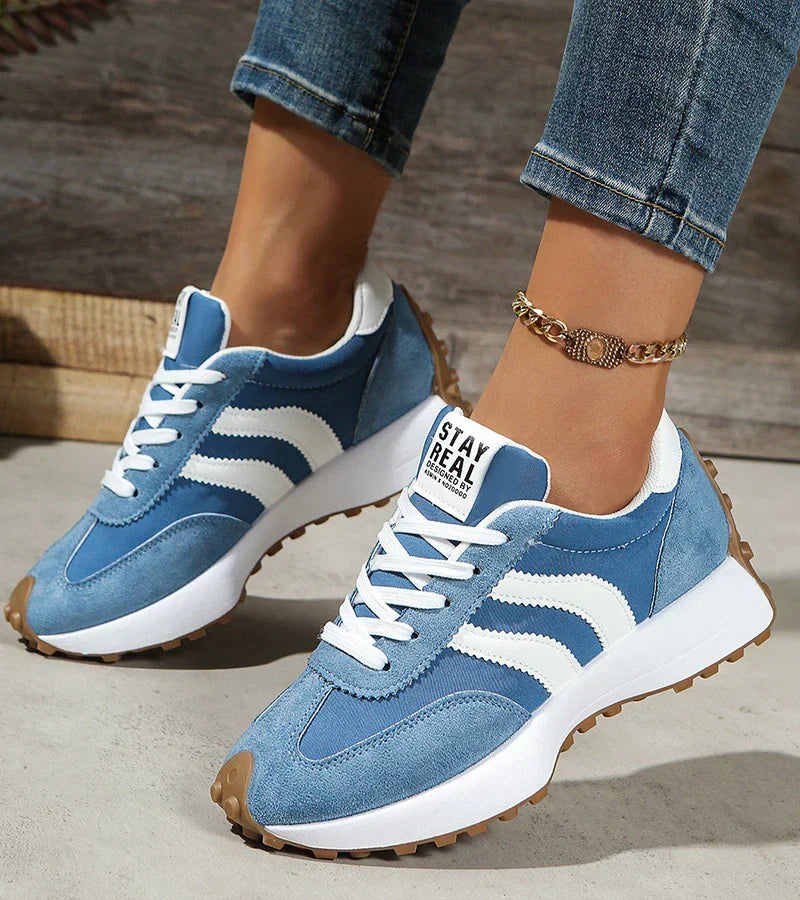 Blue and white lace-up trainers with striped panels and cushioned sole
