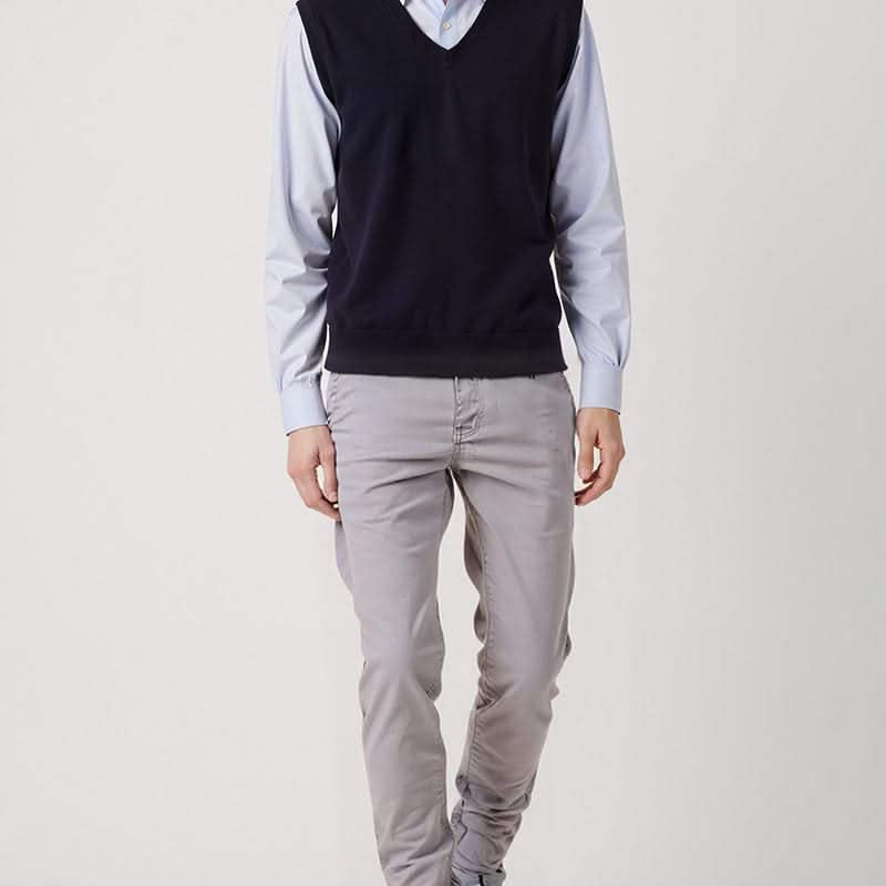Light grey slim trousers with button closure, belt loops, and tapered fit