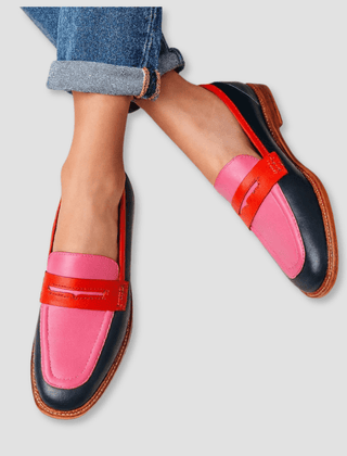 Pink and navy loafers with red strap accents and tan rubber sole