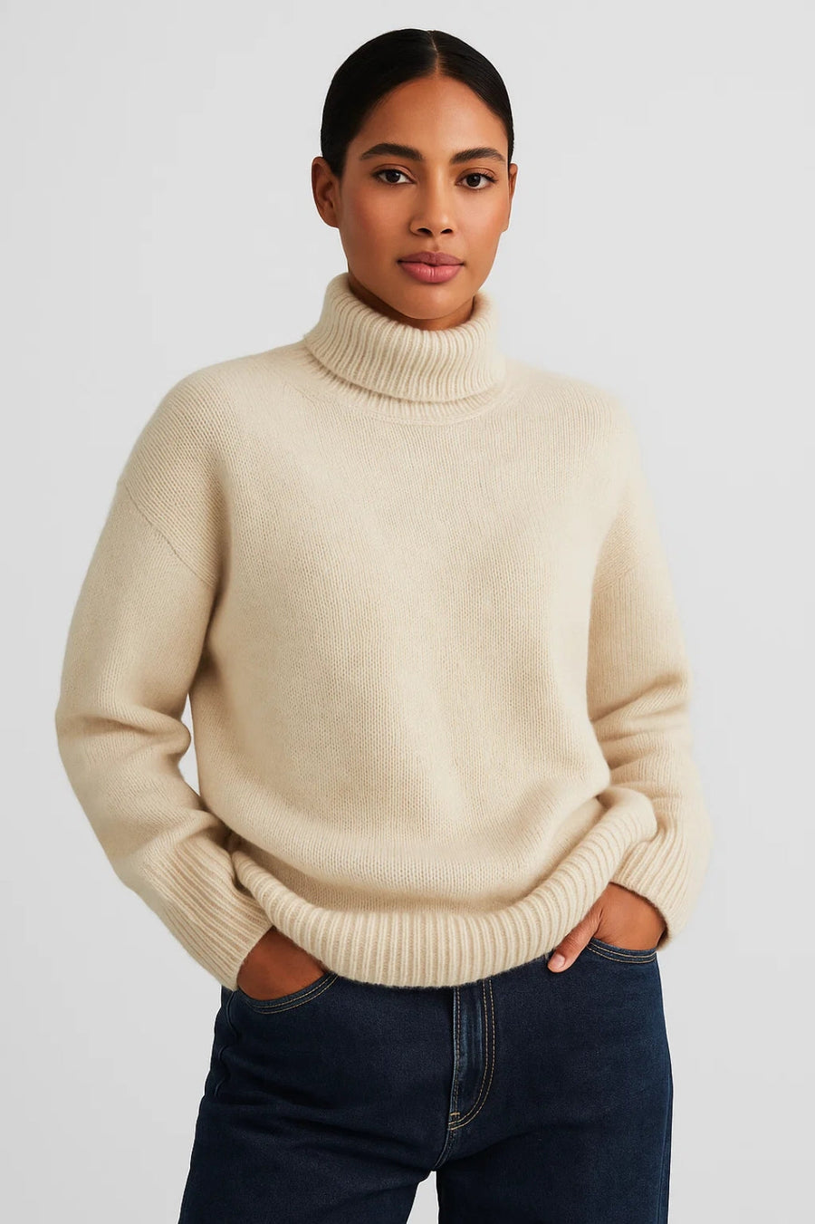 Cream roll-neck knit jumper on model, ribbed collar, cuffs, and hem