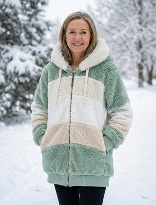 Plush colorblock jacket in sage green, cream, and light tan with zip front and hood