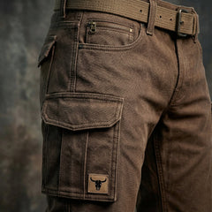 Dark brown utility pants close-up: side cargo pocket with snap and stitching
