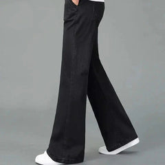 Black flare boot cut jeans shown in motion, wide leg with stitched front pockets