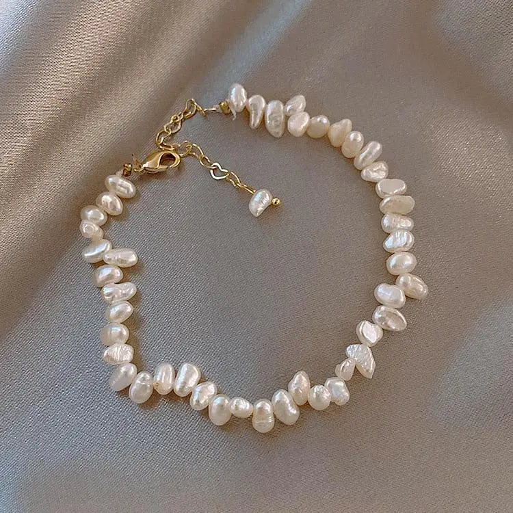 Pearl choker-style bracelet with gold-tone clasp and linked chain