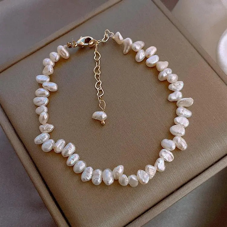 Freshwater pearl bracelet with gold-tone chain and small drop charm