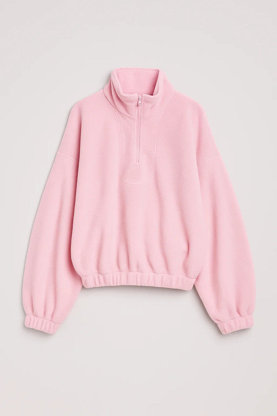 Light pink knit half-zip sweater with stand collar, dropped shoulders, ribbed hem