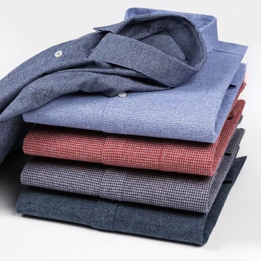 Folded KINGSMERE patterned shirts stack in blue, red, and grey, button-down collars