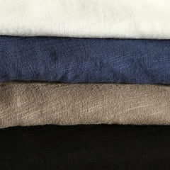 Cotton shirt cuff close-up with navy, brown, and dark fabric layers