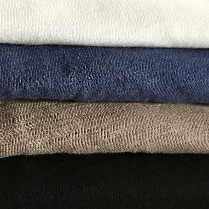 Cotton shirt cuff close-up with navy, brown, and dark fabric layers