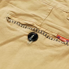 Khaki cotton shorts with buttoned pocket and woven trim