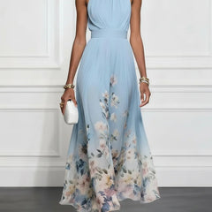 Light blue halter maxi dress with floral print, sleeveless gathered bodice and flowy skirt.