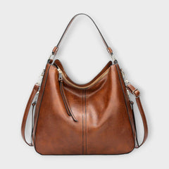 Large hobo bag in brown leather-look with front center seam and zipped top pocket