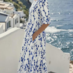 Women’s white midi dress with blue botanical print, side view, short sleeves and hem
