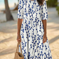 Women’s white midi dress with blue botanical print, round neckline and short sleeves