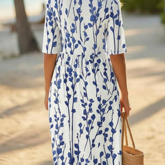 Women’s white midi dress with blue botanical print, back profile, short sleeves