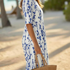 Women’s white midi dress with blue botanical print, side profile, short sleeves
