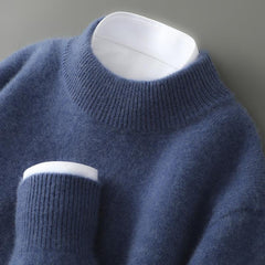 Blue soft knit mock neck jumper with ribbed collar and long sleeves.
