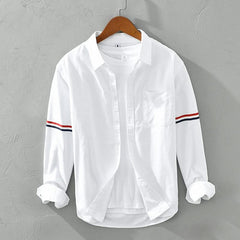White linen shirt with button front, chest pocket, and striped sleeve cuffs