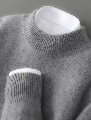Grey soft knit mock neck jumper with ribbed cuffs and long sleeves.