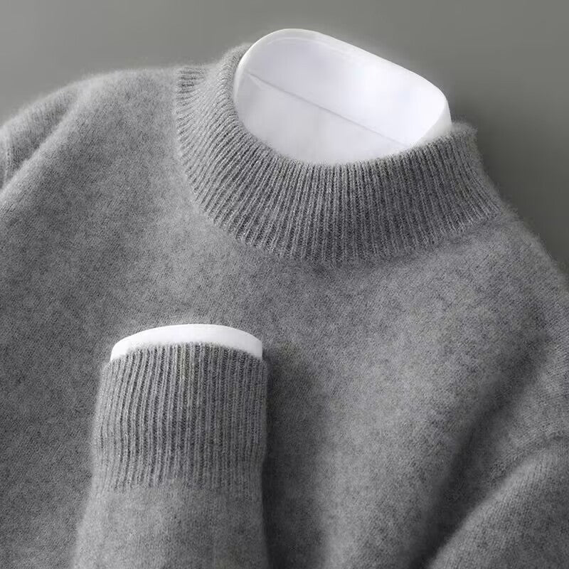 Grey soft knit mock neck jumper with ribbed cuffs and long sleeves.