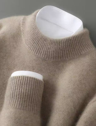 Cream soft knit mock neck jumper on a hanger, showing ribbed sleeve cuffs.