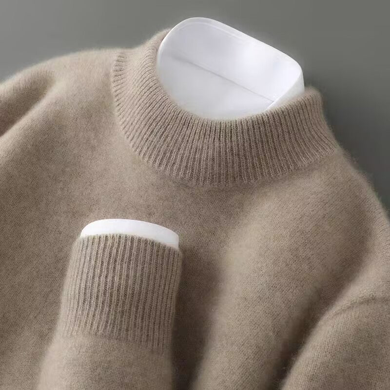 Cream soft knit mock neck jumper on a hanger, showing ribbed sleeve cuffs.