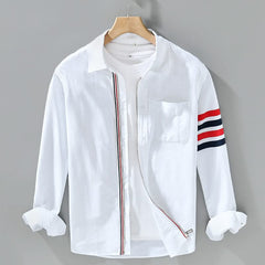 White cotton button-up shirt with chest pocket and red-striped sleeve detail
