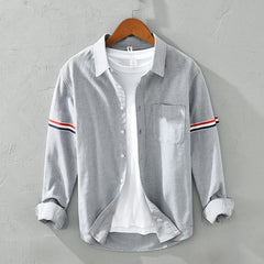 Gray linen shirt with button front, chest pocket, and striped sleeve cuffs