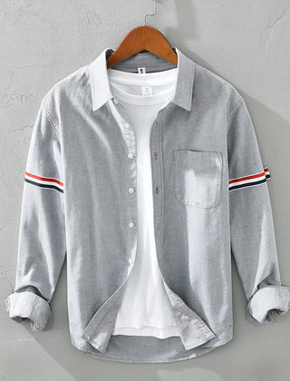Gray linen shirt with button front, chest pocket, and striped sleeve cuffs