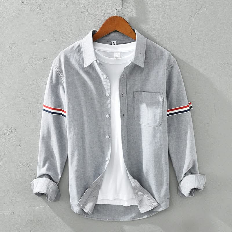 Gray linen shirt with button front, chest pocket, and striped sleeve cuffs