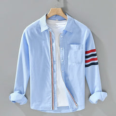 Light blue cotton button-up shirt with chest pocket and striped sleeve