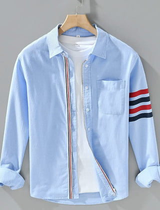 Light blue cotton button-up shirt with chest pocket and striped sleeve