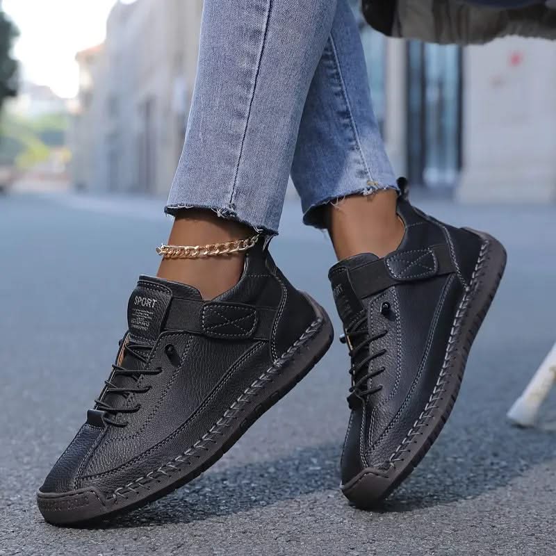 Black orthopedic high-top sneakers with lace-up front and padded side strap
