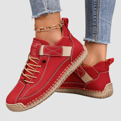 Red orthopedic high-top sneakers with lace-up front, stitched trim, and padded collar